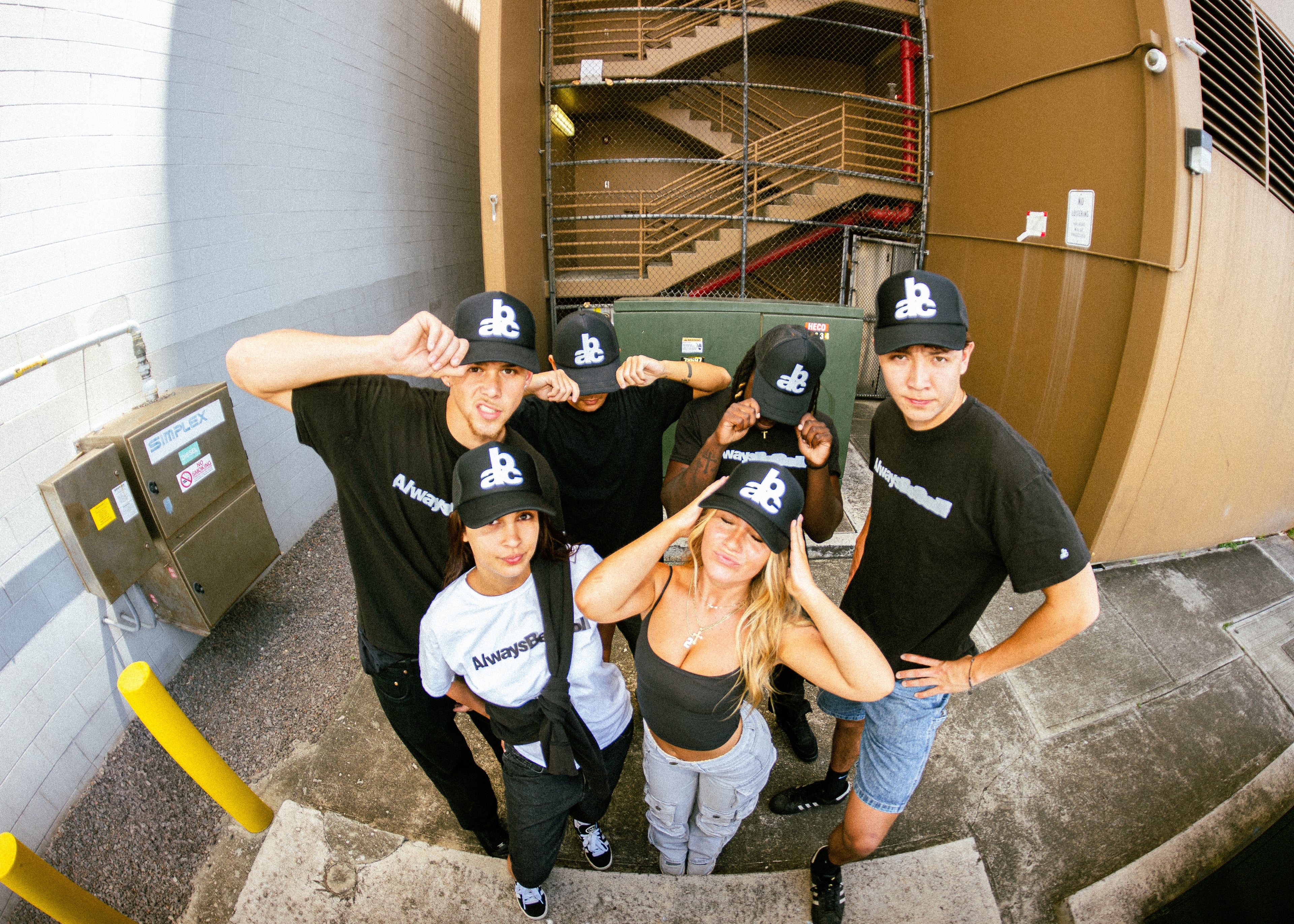 Group of people wearing branded hats in an urban setting